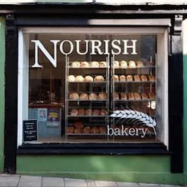 Nourish Bakery shopfront with freshly baked bread and pastries displayed in the window.
